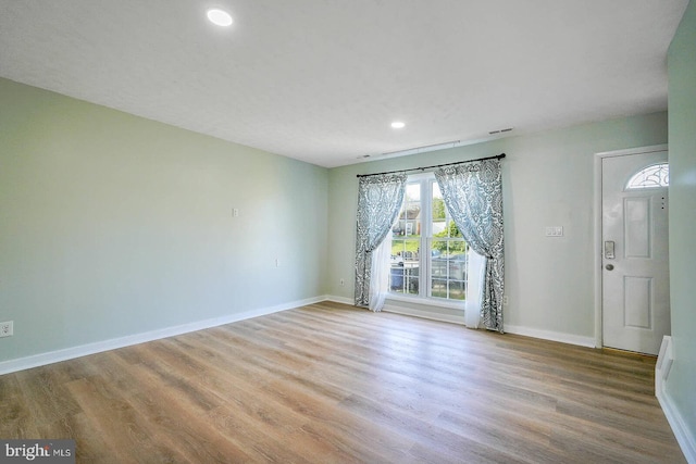 interior space with recessed lighting, wood finished floors, visible vents, and baseboards