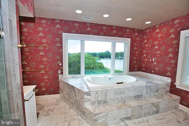 712 Riverside Pines Ct, Salisbury, MD 21801 - bathroom with baseboards, a bath, vanity, marble finish floors, and recessed lighting