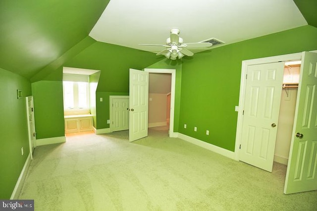712 Riverside Pines Ct, Salisbury, MD 21801 - unfurnished bedroom featuring lofted ceiling, baseboards, light colored carpet, a walk in closet, and a closet
