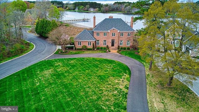 712 Riverside Pines Ct, Salisbury, MD 21801 - colonial inspired home with a water view, curved driveway, a chimney, and a front lawn