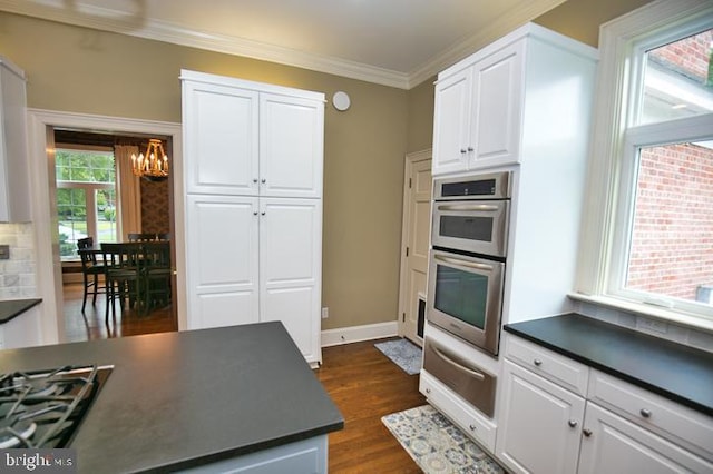 712 Riverside Pines Ct, Salisbury, MD 21801 - kitchen with dark countertops, a chandelier, double oven, a warming drawer, and white cabinets