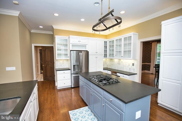 712 Riverside Pines Ct, Salisbury, MD 21801 - kitchen featuring appliances with stainless steel finishes, dark countertops, white cabinetry, tasteful backsplash, and crown molding