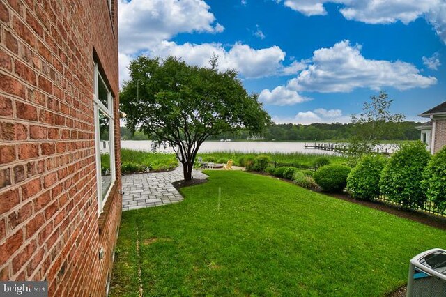 712 Riverside Pines Ct, Salisbury, MD 21801 - view of grassy yard with a water view and a patio area