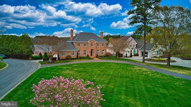 712 Riverside Pines Ct, Salisbury, MD 21801 - colonial inspired home with curved driveway, a front lawn, and a chimney