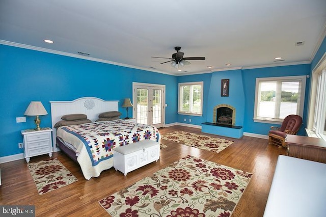 712 Riverside Pines Ct, Salisbury, MD 21801 - bedroom with access to outside, multiple windows, baseboards, wood finished floors, and ornamental molding