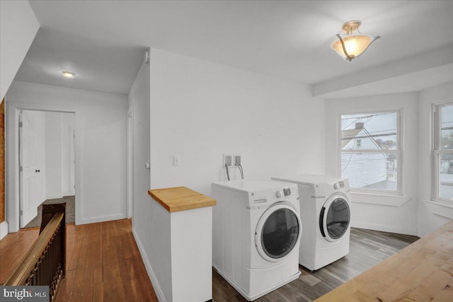 laundry room featuring washer and clothes dryer, dark wood-style flooring, laundry area, and baseboards