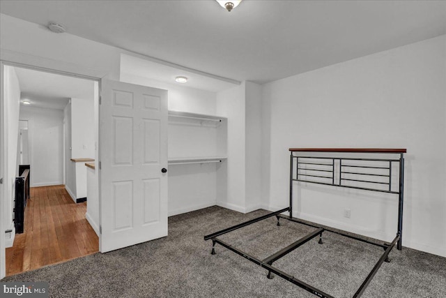 bedroom with a closet, carpet flooring, and baseboards