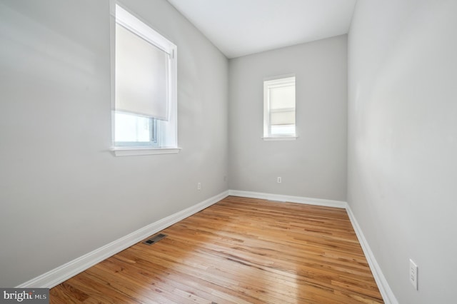 empty room with visible vents, baseboards, and light wood-style flooring