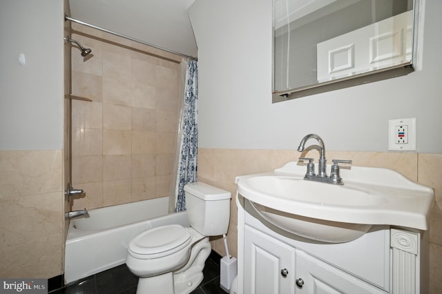 full bath with vanity, toilet, shower / tub combo with curtain, tile walls, and tile patterned floors