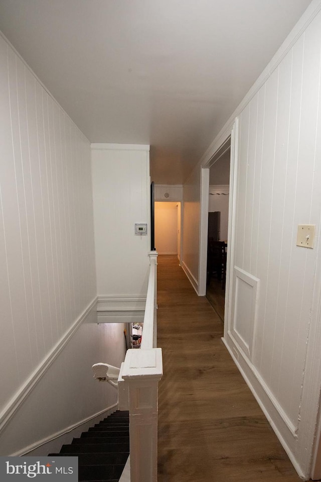 hallway featuring dark wood-type flooring and an upstairs landing