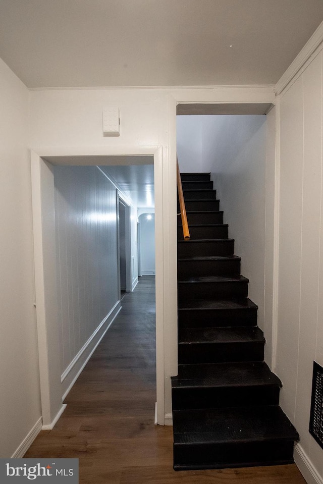 stairs with baseboards and wood finished floors
