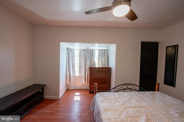 bedroom with wood finished floors, ceiling fan, and baseboards