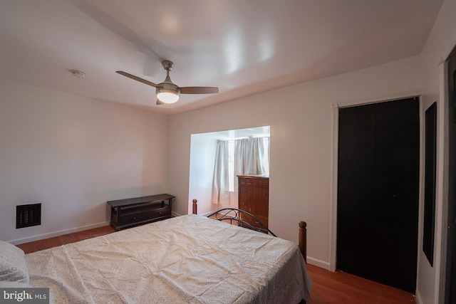 bedroom with baseboards, a ceiling fan, and wood finished floors