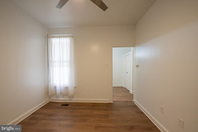 unfurnished room with wood finished floors, ceiling fan, baseboards, and visible vents
