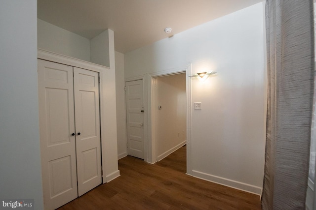 hallway with wood finished floors and baseboards