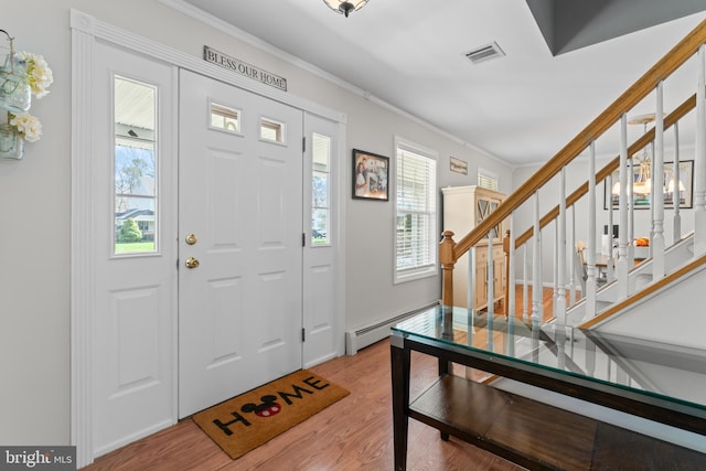 132 Heatherington Ct, Lanoka Harbor, NJ 08734 - foyer entrance with wood finished floors, a baseboard heating unit, visible vents, and stairs