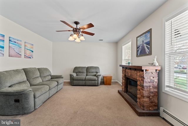 132 Heatherington Ct, Lanoka Harbor, NJ 08734 - living area with baseboards, a baseboard heating unit, a ceiling fan, a fireplace, and light colored carpet