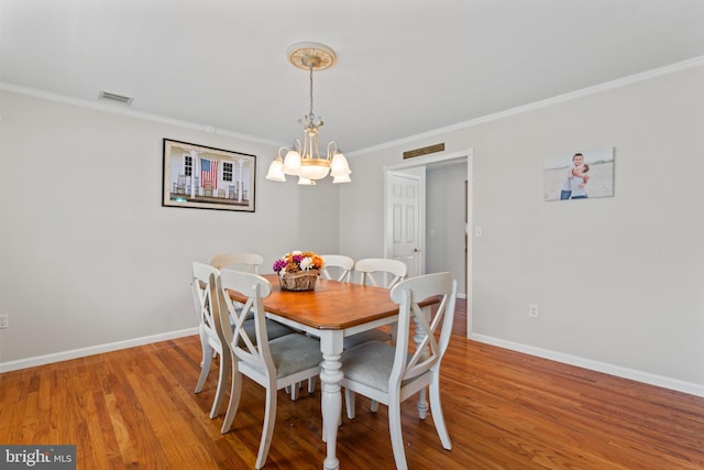 132 Heatherington Ct, Lanoka Harbor, NJ 08734 - dining room featuring baseboards, wood finished floors, a notable chandelier, and visible vents