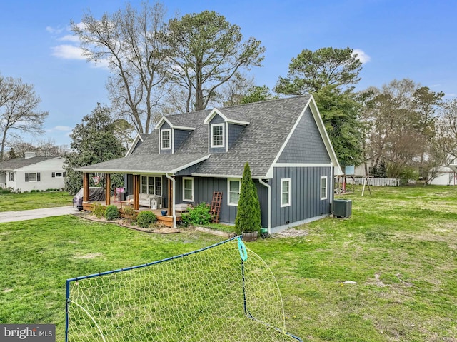 204 Canal St, Grasonville, MD 21638 - view of front facade with cooling unit, board and batten siding, a shingled roof, and a front yard