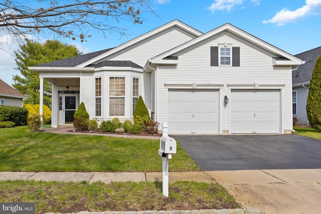 view of front of house with aphalt driveway and a front yard
