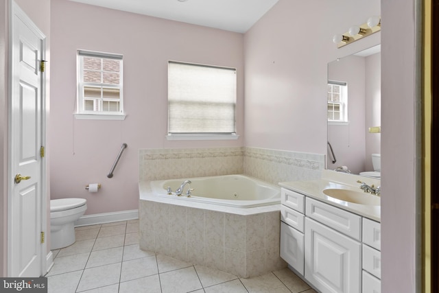 bathroom with tile patterned floors, vanity, a garden tub, and toilet