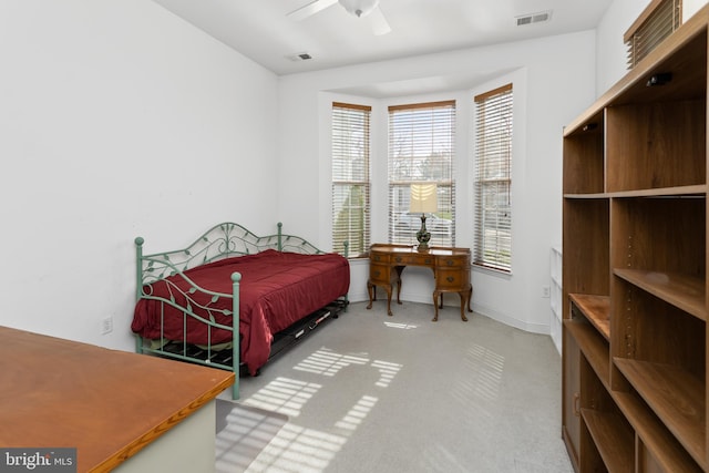 carpeted bedroom featuring visible vents, baseboards, and ceiling fan