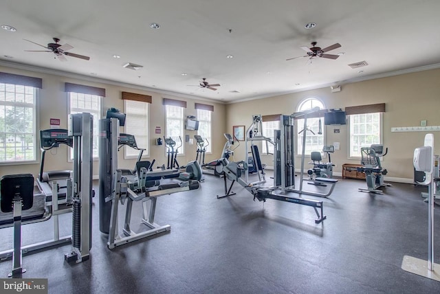 exercise room featuring visible vents, baseboards, a ceiling fan, and ornamental molding