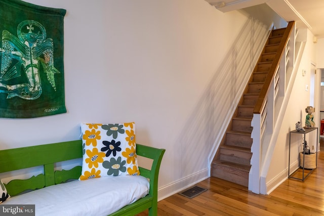 bedroom featuring visible vents, baseboards, and wood finished floors