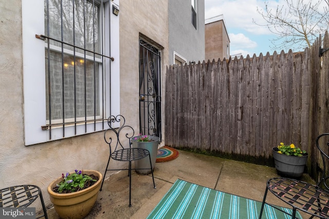 view of patio / terrace featuring fence