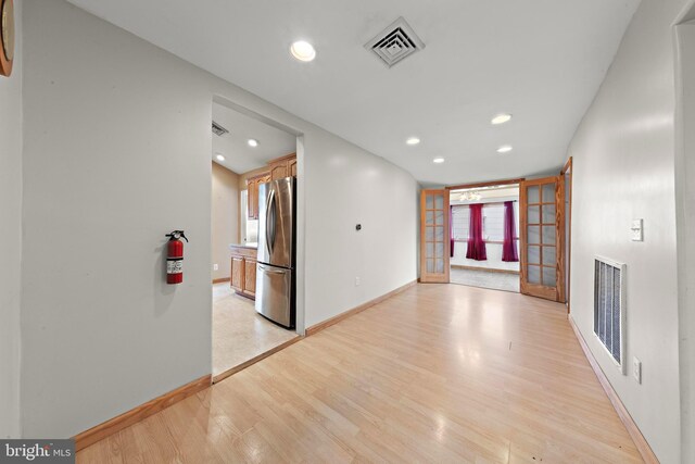 unfurnished living room with light wood finished floors, baseboards, visible vents, and recessed lighting