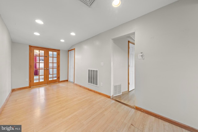empty room with french doors, visible vents, recessed lighting, and wood finished floors