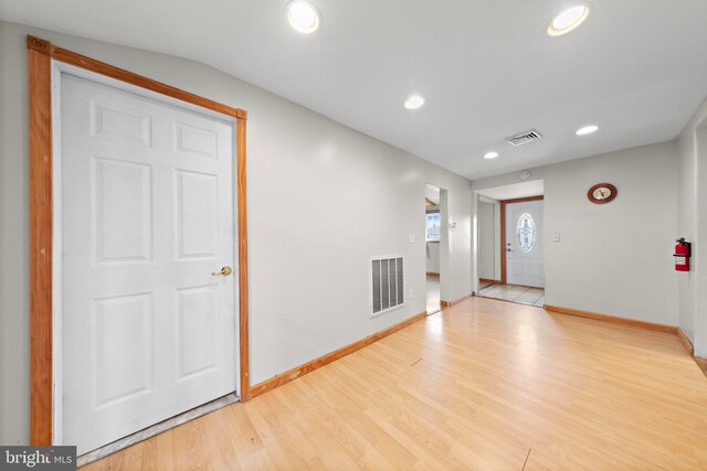 foyer featuring light wood-type flooring, baseboards, visible vents, and recessed lighting