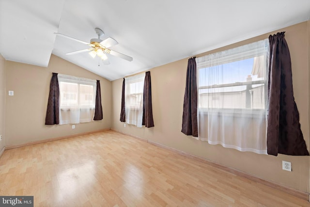 unfurnished room with a ceiling fan, wood finished floors, and lofted ceiling