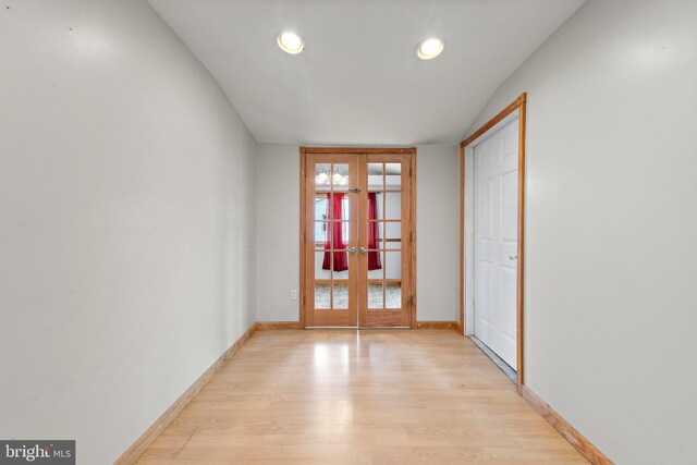 interior space featuring recessed lighting, french doors, light wood-type flooring, and baseboards