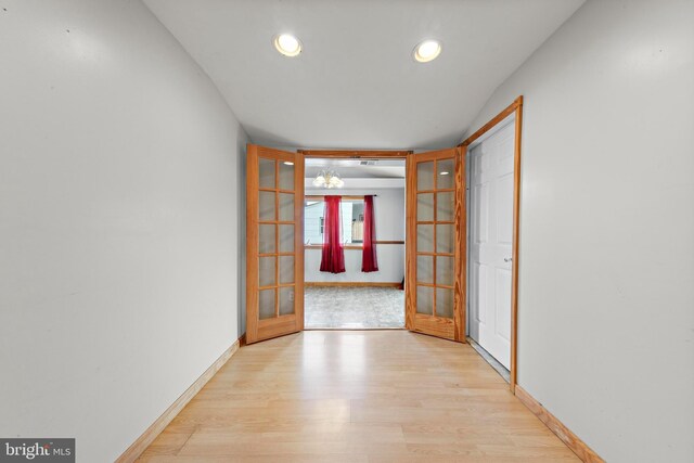 spare room with french doors, wood finished floors, baseboards, and recessed lighting