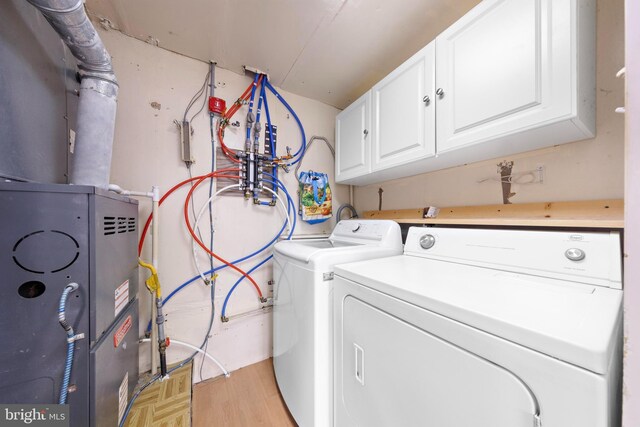 laundry area featuring cabinet space, washing machine and clothes dryer, and parquet floors