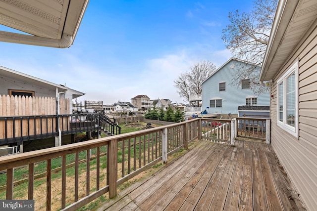 wooden deck featuring a residential view and fence