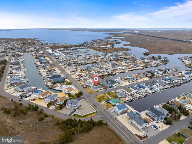 drone / aerial view featuring a residential view and a water view