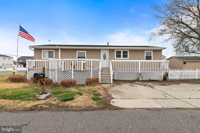 view of front of property with a wooden deck and fence