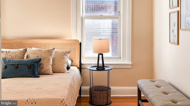 bedroom with baseboards and wood finished floors
