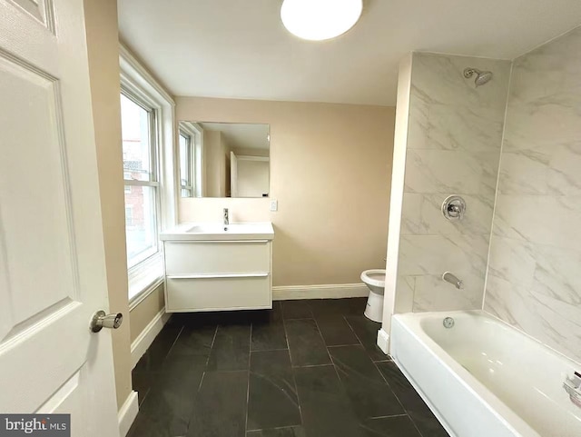 full bath with toilet, vanity, baseboards, and shower / washtub combination