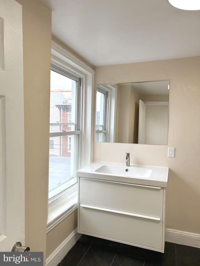 bathroom featuring tile patterned floors, vanity, and baseboards