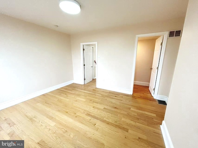 unfurnished room with visible vents, baseboards, and light wood-style floors