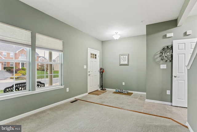 foyer entrance featuring baseboards