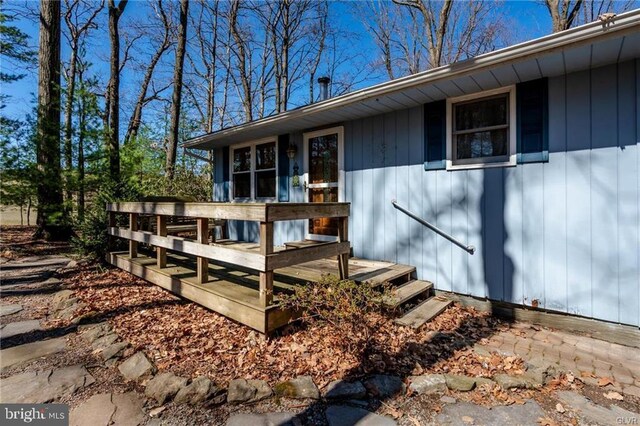 view of exterior entry with a wooden deck