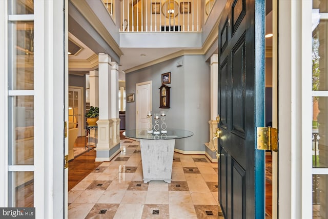 709 Pilot House Dr, Annapolis, MD 21401 - entrance foyer featuring light tile patterned floors, baseboards, crown molding, and decorative columns