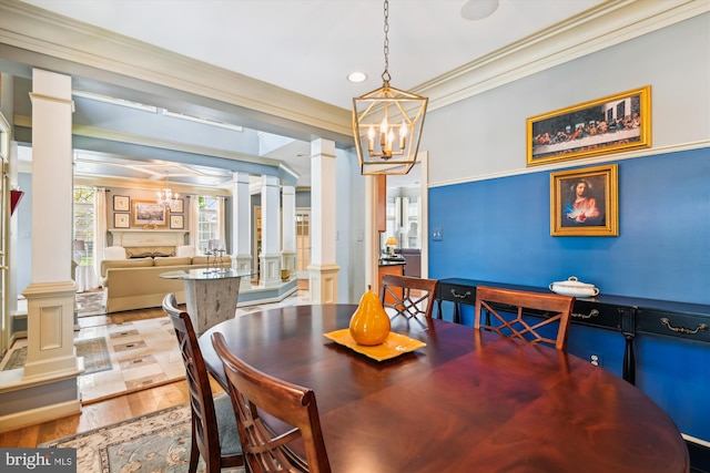 709 Pilot House Dr, Annapolis, MD 21401 - dining area with recessed lighting, ornate columns, an inviting chandelier, wood finished floors, and crown molding
