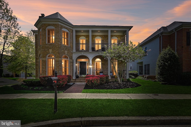 709 Pilot House Dr, Annapolis, MD 21401 - mediterranean / spanish house featuring covered porch, a balcony, a yard, and brick siding