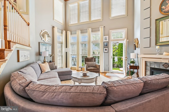 709 Pilot House Dr, Annapolis, MD 21401 - living room with stairway, a high ceiling, and a tile fireplace