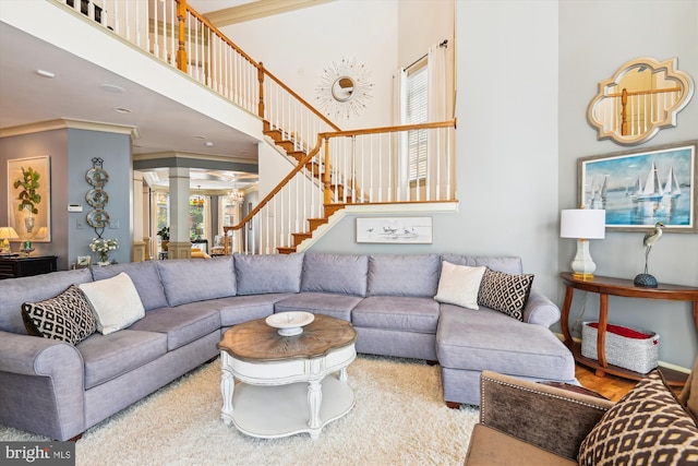 709 Pilot House Dr, Annapolis, MD 21401 - living area featuring ornamental molding, a high ceiling, and stairway